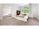 Cozy bedroom featuring a mirrored closet, soft natural light, and neutral carpeting at 7703 S Grape Ct, Centennial, CO 80122