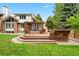 Multi-tiered deck with pergola, ideal for outdoor dining and relaxation in a beautifully landscaped backyard at 7703 S Grape Ct, Centennial, CO 80122