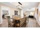 Spacious dining room features a large wooden table, a skylight, and opens to the living area at 7703 S Grape Ct, Centennial, CO 80122