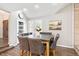 Cozy dining room with seating for eight, modern lighting, and a stylish wood burning fireplace at 7703 S Grape Ct, Centennial, CO 80122