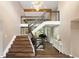 Grand foyer with a staircase, hardwood floors, a striking chandelier, and an open view to the living area at 7703 S Grape Ct, Centennial, CO 80122