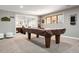 Entertaining game room with pool table, cue rack, dart board, and ample natural light at 7703 S Grape Ct, Centennial, CO 80122