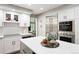Bright kitchen boasts stainless appliances, quartz countertops, white cabinetry, and large center island at 7703 S Grape Ct, Centennial, CO 80122