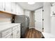 Functional laundry room features modern appliances, ample storage, and a convenient folding area at 7703 S Grape Ct, Centennial, CO 80122