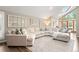 Bright living room showcasing a large sectional sofa, skylight, vaulted ceilings, and French doors at 7703 S Grape Ct, Centennial, CO 80122