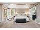 Inviting main bedroom features ample natural light, a barn door to the bathroom, and cozy decor at 7703 S Grape Ct, Centennial, CO 80122