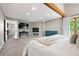Expansive main bedroom features a decorative fireplace, large windows, and neutral decor throughout at 7703 S Grape Ct, Centennial, CO 80122