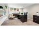 A well-lit home office with a dark desk, neutral walls, and built-in shelving providing an ideal workspace at 7703 S Grape Ct, Centennial, CO 80122