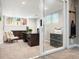 Basement office with modern desk, filing cabinet, and sliding glass door at 7703 S Grape Ct, Centennial, CO 80122
