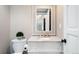Charming powder room with decorative mirror, granite countertop, and stylish fixtures at 7703 S Grape Ct, Centennial, CO 80122