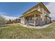 A manicured backyard with patio, lush lawn, and landscaping showcasing outdoor living at 10178 Nadine Ave, Parker, CO 80134