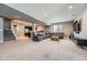 Large finished basement with rec area, stairs to upper floors and partial view of kitchen at 10178 Nadine Ave, Parker, CO 80134
