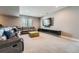 Comfortable basement living area with a leather sectional, media center and plush carpeting at 10178 Nadine Ave, Parker, CO 80134
