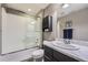 Modern bathroom with tiled shower and marble top vanity and grey accents at 10178 Nadine Ave, Parker, CO 80134