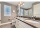 Bright bathroom featuring a double sink vanity with gray countertop and gray flooring at 10178 Nadine Ave, Parker, CO 80134