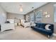 Spacious bedroom with two beds, a blue couch, and plenty of natural light from multiple windows at 10178 Nadine Ave, Parker, CO 80134