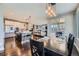 An open-concept dining area features hardwood floors, modern pendant lighting, and seamless access to the kitchen and living spaces at 10178 Nadine Ave, Parker, CO 80134