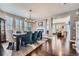 Open dining room with hardwood floors and a view to the living area at 10178 Nadine Ave, Parker, CO 80134