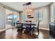 Dining area with modern lighting, table with bench, and sliding doors leading to the outside, on hardwood floors at 10178 Nadine Ave, Parker, CO 80134