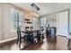 Cozy dining room with a modern chandelier, seating for six and plantation shutters for natural light on wood floors at 10178 Nadine Ave, Parker, CO 80134
