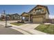 Inviting home exterior featuring a covered porch and a well-maintained lawn at 10178 Nadine Ave, Parker, CO 80134