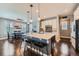 Open kitchen with center island, modern pendant lights, sleek countertops, and dark hardwood floors at 10178 Nadine Ave, Parker, CO 80134