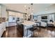 Bright kitchen with a center island, stainless steel appliances and an open view into the living room at 10178 Nadine Ave, Parker, CO 80134