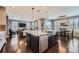 Open-concept kitchen with island seating, seamlessly connecting to the living and dining areas, with hardwood floors at 10178 Nadine Ave, Parker, CO 80134