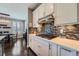 Modern kitchen featuring sleek countertops, a stylish backsplash and a view into the adjacent dining area at 10178 Nadine Ave, Parker, CO 80134