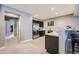 Basement kitchenette with stainless steel appliances, bar seating, and dark cabinetry at 10178 Nadine Ave, Parker, CO 80134