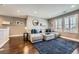 Comfortable living area with a large sectional, hardwood floors, and decoratively staged shelving at 10178 Nadine Ave, Parker, CO 80134