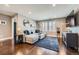 Stylish living room boasts hardwood floors, a large sectional sofa, and plenty of natural light at 10178 Nadine Ave, Parker, CO 80134
