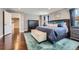 Spacious main bedroom featuring hardwood floors, blue rug and blue bedding, and neutral walls at 10178 Nadine Ave, Parker, CO 80134