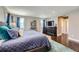 A spacious main bedroom boasts hardwood floors, neutral walls, and ample natural light from two large windows at 10178 Nadine Ave, Parker, CO 80134