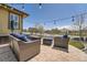 Inviting backyard patio setup with comfortable wicker furniture and stylish string lights at 10178 Nadine Ave, Parker, CO 80134