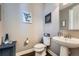 A contemporary powder room showcases clean lines, modern fixtures, and neutral tones for a serene atmosphere at 10178 Nadine Ave, Parker, CO 80134