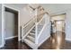 Elegant staircase with carpeted steps and white railings leading to the upper level at 10178 Nadine Ave, Parker, CO 80134