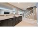 Finished basement with a full wet bar, including marbled countertop, cabinetry, and room for seating at 10178 Nadine Ave, Parker, CO 80134