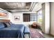 Comfortable bedroom with exposed piping, a blue quilt, and artistic décor at 1610 Little Raven St # 302, Denver, CO 80202