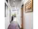Hallway leading to a bright room with a view and featuring stylish decor at 1610 Little Raven St # 302, Denver, CO 80202