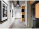 Long hallway featuring modern lighting fixtures, artwork, and access to other rooms at 1610 Little Raven St # 302, Denver, CO 80202