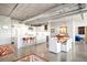 Modern open concept kitchen with concrete floors, sleek white cabinetry, and stainless steel appliances at 1610 Little Raven St # 302, Denver, CO 80202