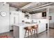 Modern kitchen with white countertops, stainless steel appliances, and adjacent seating area at 1610 Little Raven St # 302, Denver, CO 80202