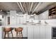 Stylish kitchen boasts white countertops, stainless steel appliances, and modern bar stool seating at 1610 Little Raven St # 302, Denver, CO 80202