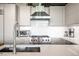 Modern kitchen featuring stainless steel appliances, a range hood, and a sink with a stylish faucet at 1610 Little Raven St # 302, Denver, CO 80202