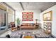 Cozy living room with leather sofa, textile wall art, and access to outdoor balcony at 1610 Little Raven St # 302, Denver, CO 80202