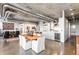 Open-concept living area with kitchen, dining, and living spaces, with polished concrete floors at 1610 Little Raven St # 302, Denver, CO 80202
