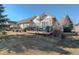 A spacious backyard deck area provides ample seating, perfect for outdoor relaxation and entertaining with views of the lawn at 8338 E 148Th Way, Thornton, CO 80602