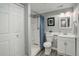 Clean, well-lit bathroom featuring a shower with blue curtain, toilet, and vanity at 8338 E 148Th Way, Thornton, CO 80602