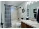 Cozy bathroom features shower over tub, vanity with tile countertop, and neutral color scheme at 8338 E 148Th Way, Thornton, CO 80602